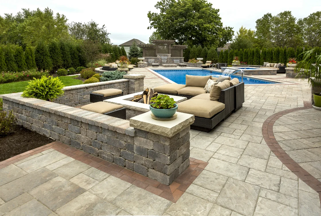 Natural stone steps, walls and patio in a landscaped outdoor setting